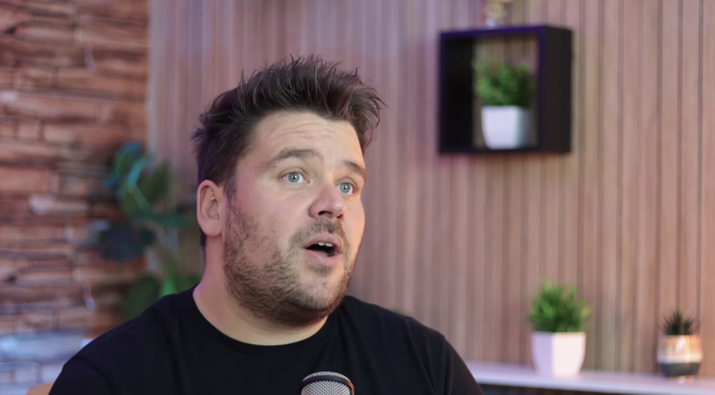 Shaun Sparks speaking into a microphone in his studio